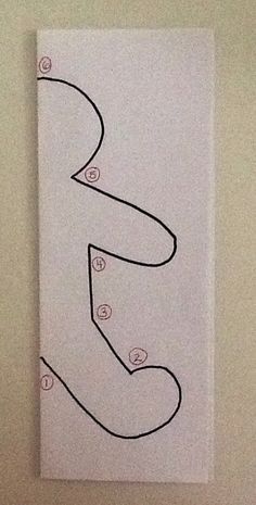 a drawing of the letter s on a piece of paper that is taped to a wall