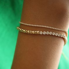 The Baby Tennis bracelet is the perfect way to add an ultra dainty touch of sparkle to your bracelet stack. It is gold-filled so it can be worn in the shower.   Chain Width: 1mm (super tiny)  Chain Length: Adjustable between 6.5” and 7.5” inches  Stones: 5A Cubic Zirconia  18k Gold filled  Handle with care and avoid contact with chemicals. Gold Minimalist Tennis Bracelet With Adjustable Chain, Minimalist Gold Tennis Bracelet With Adjustable Chain, Minimalist Gold Tennis Bracelet For Everyday, Dainty Stackable 14k Gold Filled Chain Bracelet, Dainty Diamond Bracelet For Party, Dainty 14k Gold Tennis Bracelet, Tarnish Resistant, Dainty 14k Gold Tennis Bracelet, Dainty Yellow Gold Tennis Bracelet, Gold Dainty Tennis Bracelet With Adjustable Chain