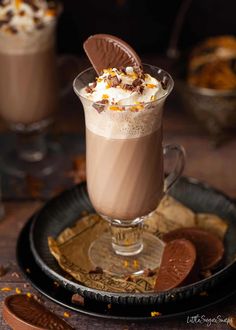 two glasses of hot chocolate drink with whipped cream on top