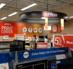 the interior of a print center with signs and other items