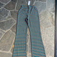 New Urban Outfitters Woman’s Small Teal Orange Black And Cream Striped Pants With Elastic Waist.The Pants Have A Flare At The Bottom Retro Loungewear Pants With Elastic Waistband, Retro Wide Leg Pants For Loungewear, Casual Fitted Orange Bottoms, Green Wide Leg Bottoms By Urban Outfitters, Fitted Green Bottoms From Urban Outfitters, Retro Wide Leg Loungewear Bottoms, Multicolor Bottoms With Elastic Waistband For Fall, Retro Orange Bottoms For Spring, Orange Stretch High-waisted Pants