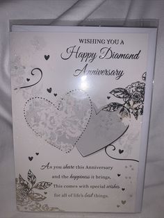 an anniversary card with two hearts on the front and back, which reads wishing you a happy diamond anniversary