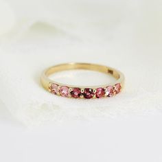 Ombre Ring Band in 14k Solid Gold, Half Eternity Gradient Pink Tourmaline Ring, Colorful Gemstone Ring, Anniversary Gift, October Birthstone . DETAILS ABOUT THE RING, MATERIALS AND STONE Ring Band: 14K YELLOW GOLD Ring Band size: 2.54mm wide band Gemstones: 2mm natural pink gradient tourmalines. Pave setting. 2mm tall from finger. Total 7 pink tourmalines. Matching hoop earrings are available from this link; https://www.etsy.com/listing/1164157904/pink-tourmaline-hoop-earrings-14k-gold? SIZE : P Gift Sapphire Ring With Half Eternity Round Band, Sapphire Half Eternity Ring As Gift, 14k Gold Eternity Band With Birthstone For Anniversary, 14k Gold Eternity Band With Birthstone, Yellow Gold 14k Eternity Band With Birthstone, Fine Jewelry Birthstone Ring With Half Eternity Band, 14k Yellow Gold Eternity Band With Birthstone, Yellow Gold Eternity Band With Birthstone, Gift Ruby Ring With Half Eternity Round Band