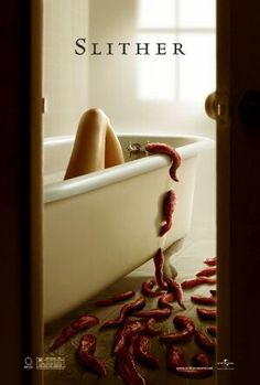 a woman laying in a bathtub with worms crawling on the floor next to it