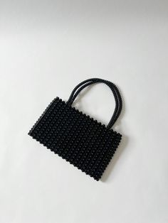 Amazing vintage black beaded hand bag, to elevate any outfit. No tags CONDITION: Great vintage condition. All beads look intact ( no missing beads ) Inside is very clean MEASUREMENTS: Rectangle bag : body Approx 11.5 inches  length X 7 inches tall. Top straps to bottom of bag : 13 inches Any questions regarding this listing, please dont hesitate to contact via DM. Please note these items are vintage/ second hand, they will have some signs of wear. If any major damage, it will be mentioned on the listing description. No returns or exchanges allowed Follow Sue's Market on Instagram @sues.mkt for daily updates, sneak peeks on new finds, and daily style inspo. Beaded Rectangular Shoulder Bag For Formal Occasions, Formal Rectangular Beaded Shoulder Bag, Formal Beaded Rectangular Shoulder Bag, Evening Rectangular Bags With Black Beads, Black Rectangular Evening Bag With Pearl Handle, Evening Rectangular Shoulder Bag With Black Beads, Formal Black Bag With Black Beads, Elegant Black Shoulder Bag With Pearl Handle, Formal Rectangular Bag With Black Beads