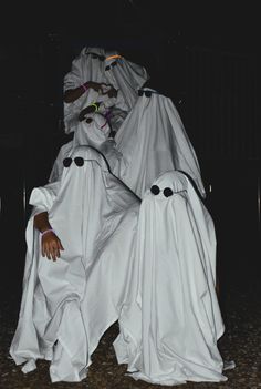 two people dressed in white ghost costumes