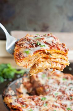 a piece of lasagna being lifted from a skillet