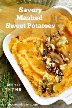 mashed sweet potatoes in a white dish with nuts and thyme on the side