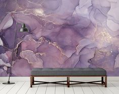 a living room with a couch and purple marble wallpaper on the walls, along with a floor lamp