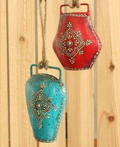 two red and blue vases hanging from strings