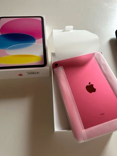 an apple box is open and sitting next to it's new pink ipad case