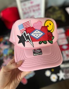 Pink foam trucker hat with custom iron on patches: -Arkansas flag -US flag -smile face -rose -lightning bolt -star Iron On Patch Trucker Hat, Patched Trucker Hat, Trucker Hat Patches, Patch Trucker Hat, Trucker Hats With Patches, Arkansas Flag, Custom Iron On Patches, Erimish Bracelets, Dorm Stuff