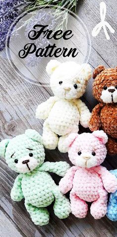 four crocheted teddy bears sitting next to each other on top of a wooden table