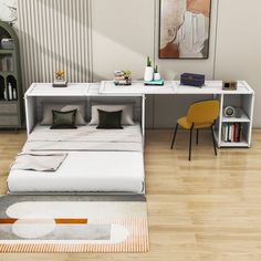 a white bed sitting next to a wooden floor