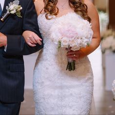 a bride and groom walking down the aisle