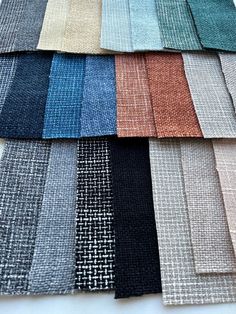 several different colors of fabric laid out on a white table top with the same color swatches