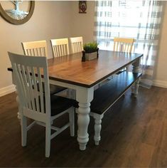 a dining room table with chairs and a bench