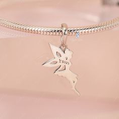 This is charm only, bracelet is sold separate. Enhance your jewelry collection with the addition of this charming pixel fairy pendant charm. Made of solid 925 sterling silver with a platinum plating and adorned with cubic zirconia decoration, this elegant fairy elf design is sure to capture your heart. Add it to your bracelet or necklace, or give it as a gift to a loved one to add a touch of magic and sparkle to their daily wear. Experience the enchantment of this exquisite fairy charm, beautifu Fairy Style Silver Jewelry For Gift, Fairy Style Sterling Silver Jewelry, Whimsical Sterling Silver Charms Jewelry, Whimsical Silver Dangling Charms, Silver Pendant Charms With Cubic Zirconia, Silver Cubic Zirconia Pendant Charms, Elegant Sterling Silver Butterfly Charm, Whimsical Silver Charms For Gifts, Whimsical Silver Jewelry With Butterfly Charm