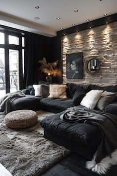 a living room filled with black furniture and pillows