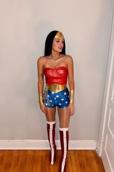 a woman dressed in wonder costume posing for the camera