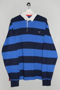 "Gant Long Sleeve Polo Shirt - Size tag: Please always check measurements before buying. Men's 2XL - Measurements (laying flat): Pit to Pit: 24.5\" Length: 29\" Sleeve: 27.5\" Pit to Cuff: 23\" Across the Shoulders: 21\" -Wear: /Please see images for details/ Good used condition. -Flaws: / serious wear, tears, holes, marks or stains/ Please see images for details. None. - Fabric: 100% Cotton -Flaws: / serious wear, tears, holes, marks or stains/ Please see images for details. A small hole down on the side stich and a small fabric defect below the logo, please look at the last two photos. *All of our items are preloved pieces so some signs of natural wear and age are to be expected. Please look through the photos carefully to check if the condition is to your satisfaction. *All efforts are Long Sleeve Cotton Polo Shirt For College, Cotton Long Sleeve Polo Shirt For College, Striped Long Sleeve Polo Shirt, Long Sleeve Blue Shirt For College, Blue Long Sleeve Shirt For College, Classic Blue College Tops, Classic Blue Top For Everyday Wear, Navy Long Sleeve Cotton Polo Shirt, Blue Long Sleeve Cotton Polo Shirt