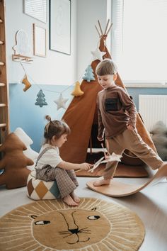 two young children playing in a play room