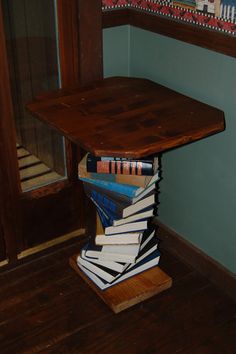 a stack of books sitting on top of a wooden table