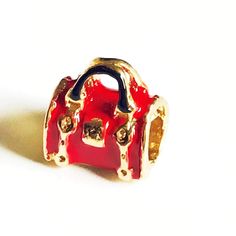 Red Bag European Bead Charm 18kt of Gold PlatedCreate your own personal Charm Chain or Bracelet, mixed and match. Crafted with 10 layers of gold 18k with high-quality gold plating Manufactured on Brazil.Warranty for up to a year against tarnishNickel and Allergies Free.Style: Dangle Beads Charm Bracelet / or Chain Charm Color: GoldtoneMetal: Brass / Gold overlayFinish: High polish / Enamel Colgantes en Oro Laminado de Brazil con 8 capas de oro 18ktsGarantia por descoloramieto.****NOT SOLID GOLD* Gold-plated Charms With Removable Features, Elegant Everyday Jewelry With Charms, Everyday Gold Metal Charms, Gold Jewelry With Removable Charms For Everyday, Elegant Gold-tone Charms With Removable Features, Elegant Gold-tone Charms With Removable Feature, Everyday Red Metal Jewelry, Elegant Gold-tone Charms For Gift, Elegant Gold-tone Charms For Gifts