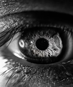 an extreme close up shot of the iris of a person's eye, looking into the distance