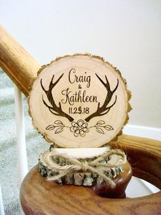 a wooden slice with the names of two deer antlers on it sitting on top of a chair