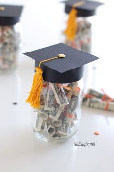 a graduation cap sitting on top of money in a jar