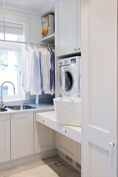 a washer and dryer in a white kitchen