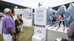 people are standing around with skis and water bottles on display in front of them