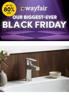 a white sink sitting under a window next to a purple sign that says, our biggest - ever black friday