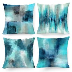 four pillows with blue and white paint on them, each one has an abstract design