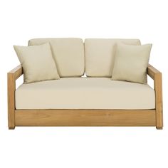 a wooden couch with four pillows on it's back and two sides, in front of a white background