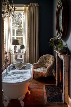 an old fashioned bathtub in the middle of a room