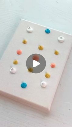 a white book with colorful polka dots on it