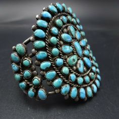 "OLD NAVAJO BRACELET DESCRIPTION: This exquisite cuff features round and oval cabs of old natural turquoise set in micro serrated bezel. This fabulous vintage bracelet will be a cherished addition to your collection of fine vintage Native American jewelry. MEASUREMENTS: Interior of the cuff measures 5\" with an additional 1\" slightly adjustable gap. Total circumference: 6\" Measures 2 1/8\" straight across the widest part (from wrist bone to wrist bone) Bracelet face measures 2 1/2\" wide (the Vintage Adjustable Gemstone Cuff Bracelet, Adjustable Vintage Gemstone Cuff Bracelet, Handmade Turquoise Vintage Cuff Bracelet, Vintage Cabochon Bangle Jewelry, Blue Oval Vintage Cuff Bracelet, Antique Turquoise Adjustable Bracelet, Antique Adjustable Turquoise Bracelet, Vintage Cabochon Bangle Bracelets, Oval Turquoise Collectible Bracelet