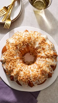 a white plate topped with a cake covered in frosting