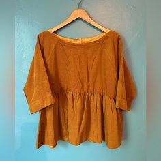 There Are So Many Gorgeous Details On This Top From Anthropologie! It’s A Rich Golden-Yellow Color, Fine Whale Corduroy, With A Boat Neck, Light Weight Material, With Elbow Length Sleeves. There Are Cute, Functional Buttons Down The Back, The Top Comes With The Extra Button. The Length Shoulder To Hem Is 24 Inches And The Bust Is 22.5 Inches Laying Flat. This Top Is A Size Small, But It Is Oversized. No Damage, Excellent Condition, Never Worn. Smoke Free Home. Mustard Short Sleeve Tops For Fall, Fall Yellow Cotton Blouse, Yellow Fall Blouse For Daywear, Yellow Cotton Blouse For Fall, Yellow Fall Daywear Blouse, Oversized Yellow Casual Blouse, Mustard Relaxed Fit Top For Spring, Casual Mustard Cotton Blouse, Yellow Short Sleeve Blouse For Fall