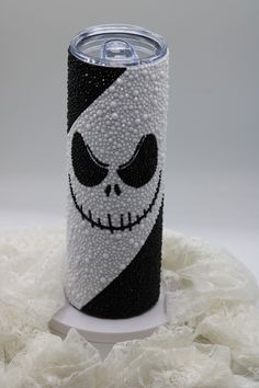 a black and white can with a skull painted on it