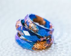 two blue rings with gold flecks sitting on top of each other