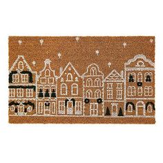 a brown door mat with white houses on it