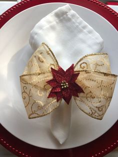 a white plate topped with a red and gold napkin