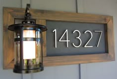 a light hanging from the side of a wall next to a sign that reads 1237