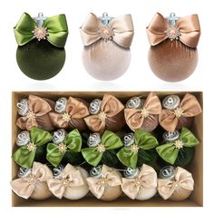 four different colored bows in a box with pearls on the top and one green bow at the bottom