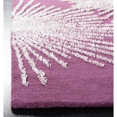 a purple rug with white designs on it