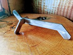 a piece of metal sitting on top of a wooden table