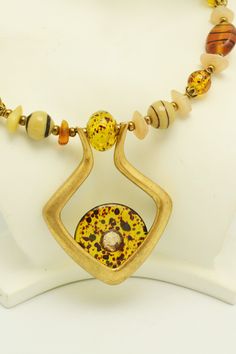 This great necklace from Chico's is strung on memory wire, and is adjustable, so it will fit a variety of sizes. Glass beads in shades of amber, cream and browns are accented by a pendant with a glass donut. This necklace will go with a lot of different outfits, and is sure to become a favorite piece. Necklace is about 18 inches long, and has an adjustment of about 4 inches. For more lovely vintage accessories, please visit: www.etsy.com/shop/CloesCloset?section_id=10559789 Adjustable Amber Glass Necklaces, Adjustable Amber Glass Necklace, Adjustable Costume Jewelry Necklace With Spacer Beads, Adjustable Round Necklace With Czech Glass, Adjustable Yellow Necklace With Spacer Beads, Wedding Gowns With Sleeves, Bead Choker, Vogue Sewing, Vogue Sewing Patterns